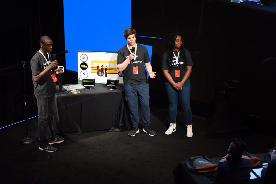 (L-R) Students Donovan Carter, Darren Labbe and Camille Kersha-Aerga of Great Bridge High School in Chesapeake, Virginia present their STEM project to address bus driver shortages to judges at the Samsung Solve for Tomorrow National Finalist Pitch Event on Monday, April 25, 2022 in New York City at Samsung 837.
