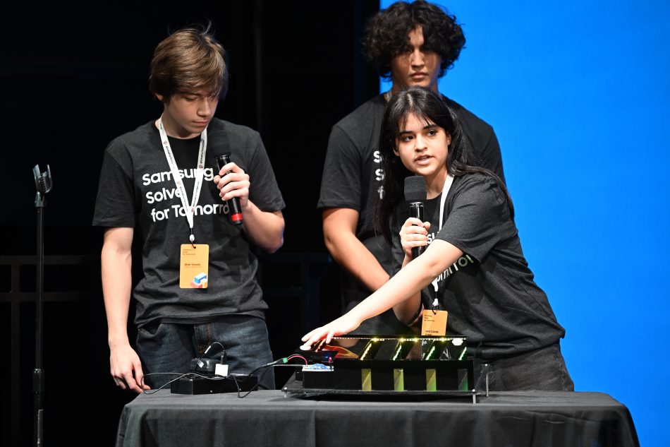 (L-R) Students River Dowdy, Johann Carranza and Lena Conde Araujo of Porter High School in Porter, Texas present their STEM project to address crowd collapse caused by an active shooter or the threat of one to judges at the Samsung Solve for Tomorrow National Finalist Pitch Event on Monday, April 25, 2022 in New York City at Samsung 837.
