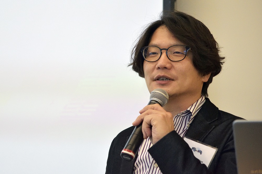 Dr. Youngkwon Lim se apresentando com um microfone na mão