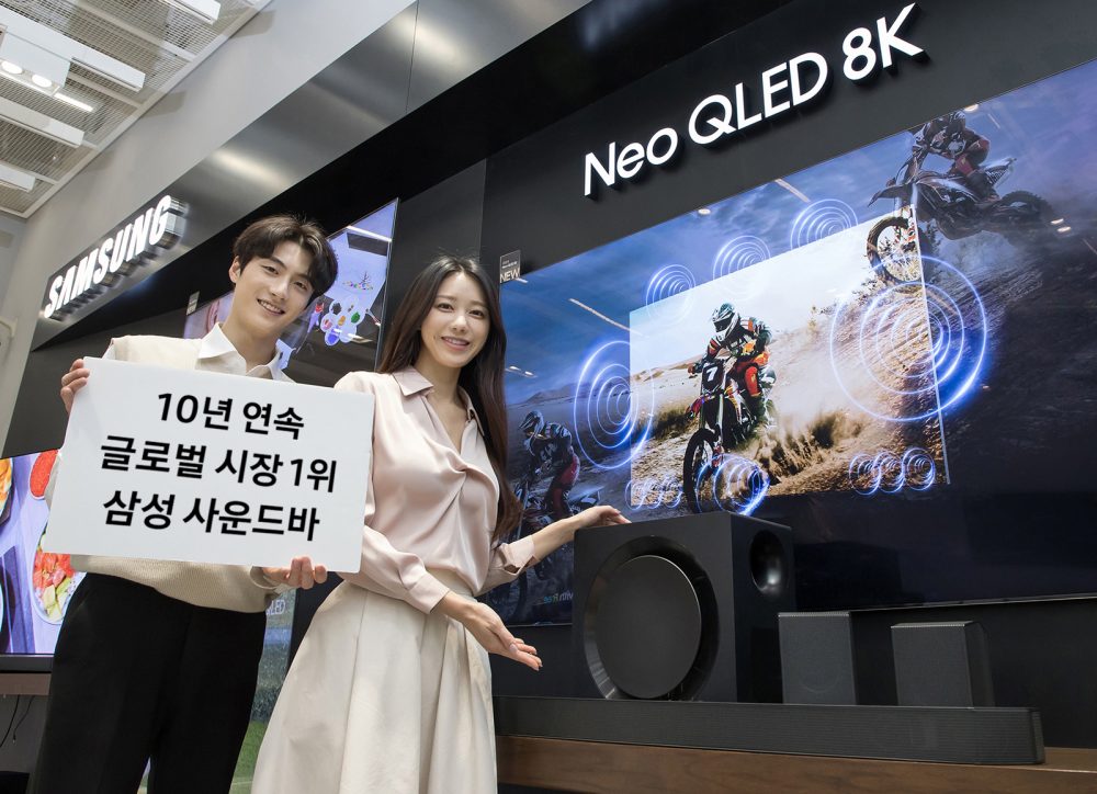 삼성전자 모델이 사운드바 10년 연속 글로벌 시장 1위 달성을 기념하며, 2024년형 사운드바 'HW-Q990D'와 2024년형 Neo QLED 8K 제품을 소개하고 있다.